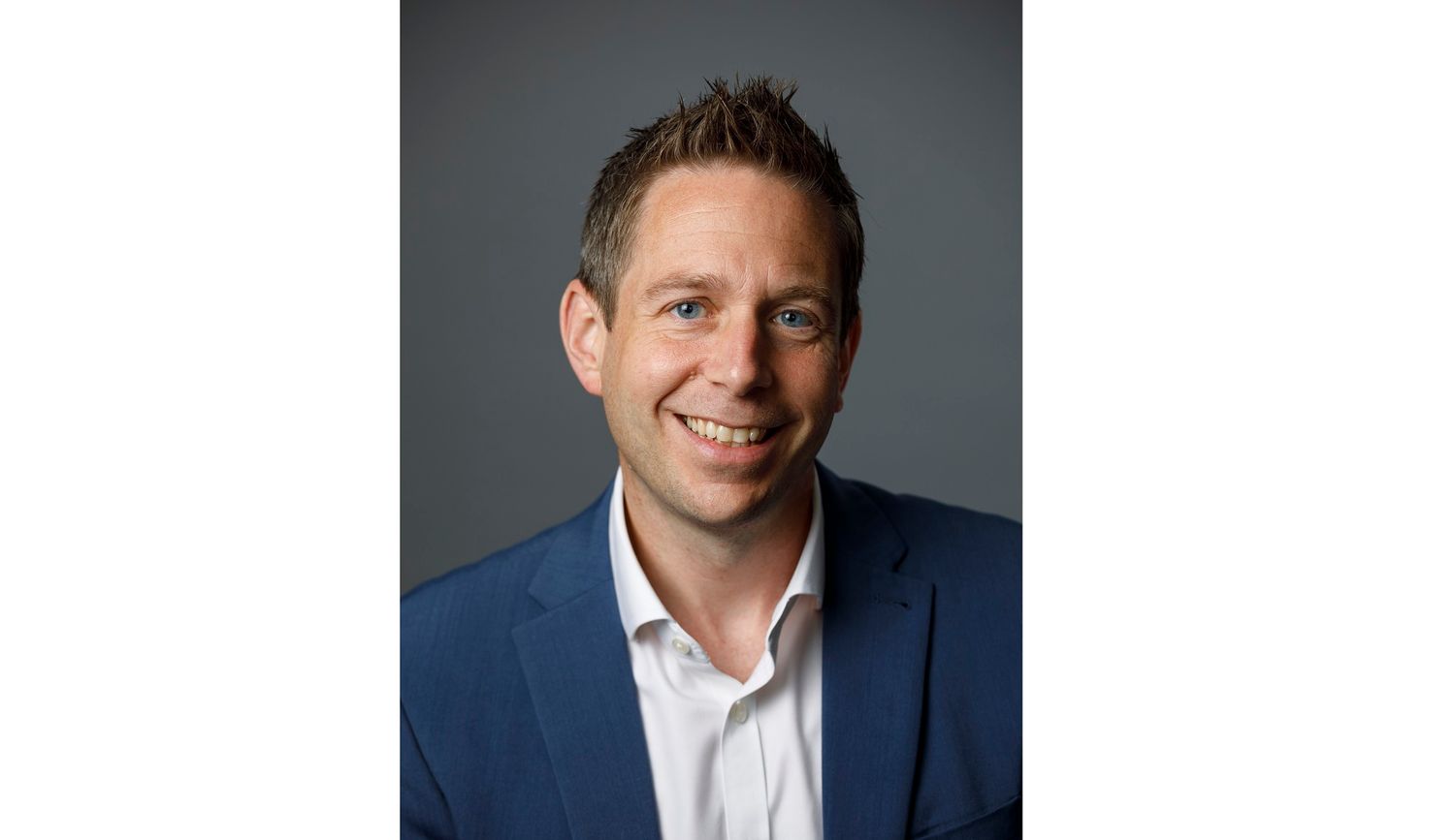 Headshot of Dr Doug Brown wearing blue suit jacket and white shirt